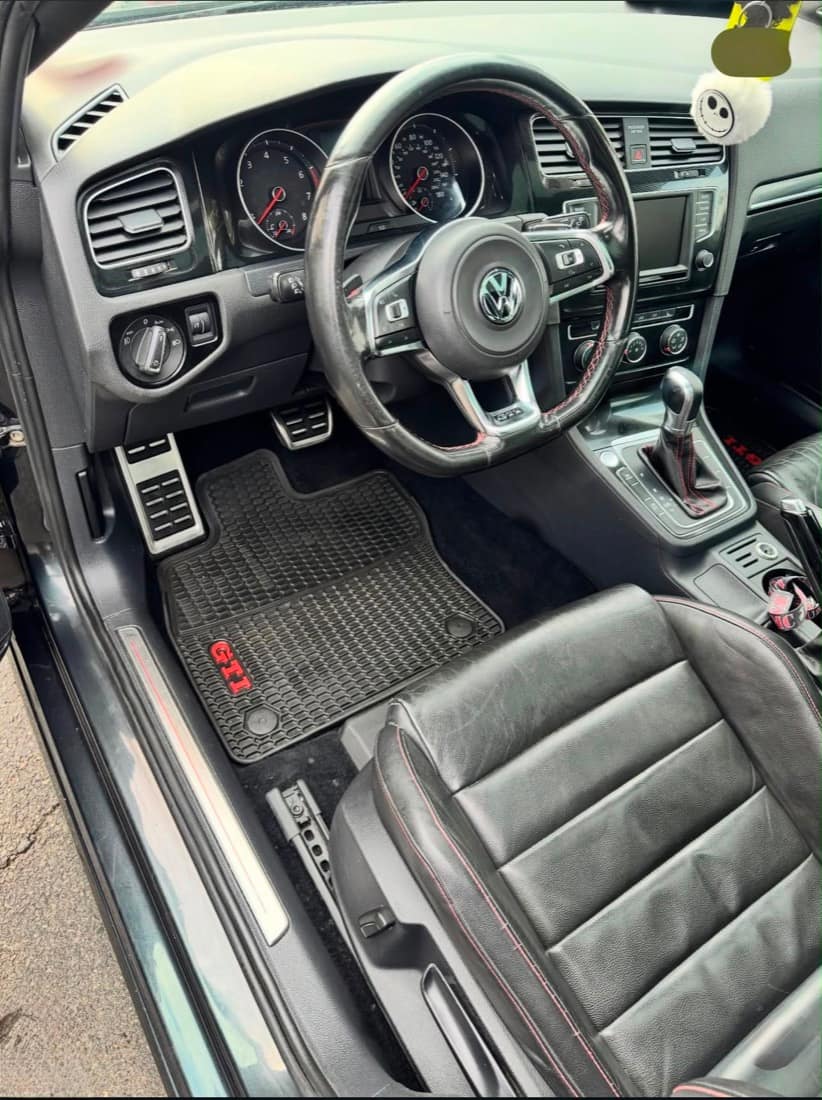 VW Golf GTI driver cockpit after detailing — cleaned leather, mat and controls